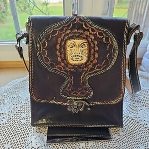 Hand Tooled Leather Crossbody With Shell Face Engraved in Front of Bag. Brown le